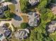 Aerial view of a home nestled among lush greenery in a developed neighborhood at 149 Cedar Woods Trl, Canton, GA 30114