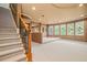 Finished basement with neutral walls, carpeted stairs, and natural light from the windows at 149 Cedar Woods Trl, Canton, GA 30114