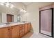 Bathroom with granite double sink, wood cabinets, large mirror, and tile shower at 149 Cedar Woods Trl, Canton, GA 30114