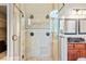 Elegant bathroom showcasing a glass shower with a tiled interior and a vanity with dual mirrors at 149 Cedar Woods Trl, Canton, GA 30114