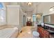 Luxury bathroom featuring a soaking tub, glass-enclosed shower, and dual vanities with granite countertops at 149 Cedar Woods Trl, Canton, GA 30114