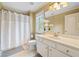 Bright bathroom with a white vanity, neutral walls, and a shower with a curtain at 149 Cedar Woods Trl, Canton, GA 30114