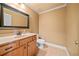 Tan powder room featuring granite countertop, wood cabinets, and neutral-colored flooring at 149 Cedar Woods Trl, Canton, GA 30114