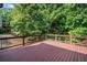 Wooden deck with railing overlooking greenery in backyard at 149 Cedar Woods Trl, Canton, GA 30114