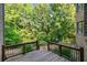 Spacious deck offering a serene view of lush greenery and backyard at 149 Cedar Woods Trl, Canton, GA 30114