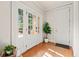 Bright foyer with natural light from the multiple windows and a decorative plant, leading into the main house at 149 Cedar Woods Trl, Canton, GA 30114