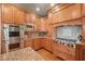 Kitchen with stainless steel double oven, cooktop, granite counters and wood cabinets at 149 Cedar Woods Trl, Canton, GA 30114