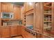 Close up of kitchen with stainless steel appliances and wood cabinets with storage at 149 Cedar Woods Trl, Canton, GA 30114