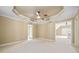 Spacious main bedroom with a tray ceiling, ceiling fan, and neutral carpet at 149 Cedar Woods Trl, Canton, GA 30114