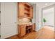 A convenient office nook features custom wood cabinets and shelving, with a chair tucked under the desktop space at 149 Cedar Woods Trl, Canton, GA 30114