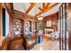 Elegant wood-paneled office featuring a fireplace, built-in bookshelves, and ample natural light at 149 Cedar Woods Trl, Canton, GA 30114