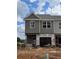New construction home showcasing a modern facade with gray siding and a single-car garage under construction at 2800 Lillian Ln, Douglasville, GA 30135