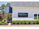 West Pines Golf Club clubhouse with white siding, black metal roof, and landscaping at 2800 Lillian Ln, Douglasville, GA 30135