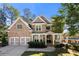 Brick two-story house with a three-car garage and landscaped front yard at 5402 Highland Preserve Dr, Mableton, GA 30126