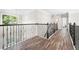 Upstairs hallway with dark hardwood floors and iron railings at 5402 Highland Preserve Dr, Mableton, GA 30126