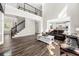 Two-story living room with hardwood floors, a white coffee table, and leather sofas at 5402 Highland Preserve Dr, Mableton, GA 30126