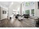 Two-story living room with hardwood floors, leather sofas, and a view of the kitchen at 5402 Highland Preserve Dr, Mableton, GA 30126