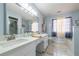 Bathroom featuring a double vanity, large mirror, walk-in shower, and a separate tub at 6432 Phillips Pl, Lithonia, GA 30058