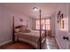 This bedroom features hardwood floors, natural lighting, and a beautiful canopy bed at 6432 Phillips Pl, Lithonia, GA 30058