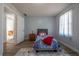 Cozy bedroom featuring a large window with natural light and a view of the outdoors at 6432 Phillips Pl, Lithonia, GA 30058