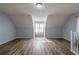 Bonus room with wood floors, natural light, and white railing at 6432 Phillips Pl, Lithonia, GA 30058