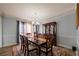 Elegant dining room with a wooden table, china cabinet, and a neutral wall color at 6432 Phillips Pl, Lithonia, GA 30058