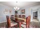 Elegant dining room with a large wooden table, chandelier, and neutral wall color at 6432 Phillips Pl, Lithonia, GA 30058