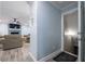 Inviting hallway leading to a living room with hardwood floors and a cozy seating area at 6432 Phillips Pl, Lithonia, GA 30058