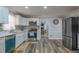 Modern kitchen with stainless steel appliances, grey backsplash, and hardwood flooring at 6432 Phillips Pl, Lithonia, GA 30058