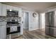 Contemporary kitchen with stainless steel appliances and tile backsplash at 6432 Phillips Pl, Lithonia, GA 30058