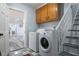 Functional laundry area with washer, dryer, and storage cabinets at 6432 Phillips Pl, Lithonia, GA 30058