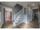 Stylish staircase with hardwood floors and white railing at 6432 Phillips Pl, Lithonia, GA 30058