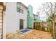 View of the backyard showing the townhouse with siding, a patio, and the privacy fence at 1023 Thornwoode Ln, Stone Mountain, GA 30083