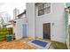 Backyard view of the townhouse with siding, an entry door, and concrete patio with geometric rug at 1023 Thornwoode Ln, Stone Mountain, GA 30083