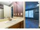 Bathroom featuring a sink vanity, and a toilet in a room connecting to another room at 1023 Thornwoode Ln, Stone Mountain, GA 30083