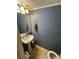 Small bathroom with pedestal sink and toilet at 1023 Thornwoode Ln, Stone Mountain, GA 30083