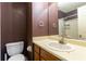 Bathroom featuring a toilet, sink vanity and bathtub shower with dark purple walls at 1023 Thornwoode Ln, Stone Mountain, GA 30083