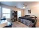 Bedroom featuring a queen size bed with zebra stripe accents, as well as dual windows at 1023 Thornwoode Ln, Stone Mountain, GA 30083