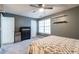 Bedroom featuring a queen bed, a black dresser, wall shelving, ceiling fan and a window at 1023 Thornwoode Ln, Stone Mountain, GA 30083