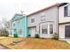 Quaint townhome featuring pastel colors, concrete walkway, and well-manicured lawn at 1023 Thornwoode Ln, Stone Mountain, GA 30083