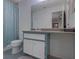 Bathroom with teal vanity and a large mirror at 1414 Branch Dr, Tucker, GA 30084