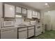 Functional kitchen with white appliances and cabinetry, alongside washer and dryer at 1414 Branch Dr, Tucker, GA 30084