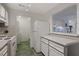 Cozy kitchen featuring white appliances and tiled floors, offering functionality and a clean aesthetic at 1414 Branch Dr, Tucker, GA 30084