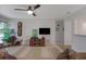 Living room with ceiling fan, television, and view to another room at 1414 Branch Dr, Tucker, GA 30084