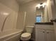 Bathroom with tub, toilet, vanity, and granite countertop at 45 Heyman Dr, Covington, GA 30016