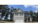 Two-story house with gray siding, a large garage, and landscaping at 45 Heyman Dr, Covington, GA 30016