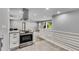 Modern kitchen island with stainless steel range and hood at 2502 Tyler Way, Decatur, GA 30032