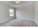 Cozy carpeted bedroom with neutral walls and a window allowing for plenty of natural light at 254 Arnewood Cir, Mcdonough, GA 30253