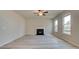 Spacious living room with fireplace, ceiling fan, and wood-look floors at 254 Arnewood Cir, Mcdonough, GA 30253