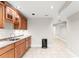 Basement kitchenette with wood cabinets and sink at 801 Treadstone Overlook, Suwanee, GA 30024